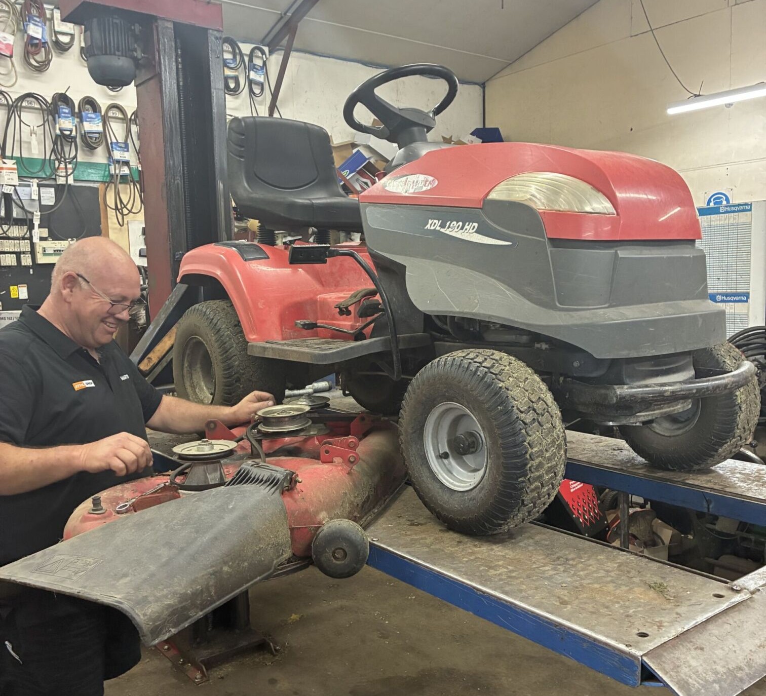 Technician performing ride on mower servicing in Morrinsville to maintain reliable outdoor power equipment performance.